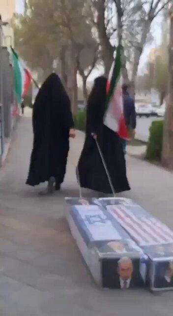 @Masih Alinejad: They have put Trump and Netanyahu in coffins, portraying them as dead bodies and dragging the coffins through the streets.
These two women are Basij supporters taking part in a government-organized r