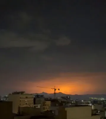 @Babak Taghvaee - The Crisis Watch: Massive fire and explosions can be seen behind Bibi Shahrbanu Mountain in eastern Tehran as a result of heavy airstrikes conducted by U.S. and Israeli air forces against ballistic missile production f