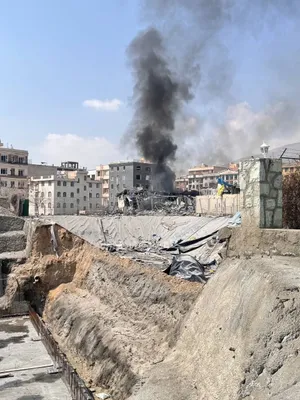@Vahid Online: Received message along with the first two images: They struck above the Janat Abad flower market an hour ago. [It must be around 12:30]  
It continued: 'That shed was full of ammunition and personnel.