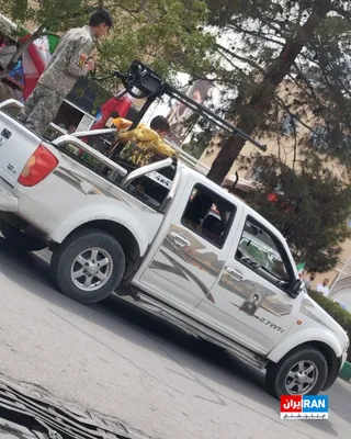 @ايران اينترنشنال: An image sent to Iran International on April 9 shows children riding on a military vehicle and positioned behind a machine gun in the city of Qom. One of these children, on the verge of adolescence, i