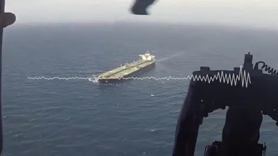 @Open Source Intel: U.S. Navy is now in control. 

Audio recorded aboard the USS Michael Murphy (DDG 112), paired with aerial footage from its helicopter over the Gulf of Oman, captures a U.S. Navy diversion of a commerc