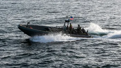 @U.S. Central Command: U.S. forces patrol the Arabian Sea near M/V Touska, April 20, as the Iranian-flagged vessel's container cargo is searched after U.S. Marines boarded and seized the ship when it attempted to violate th
