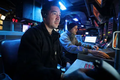 @U.S. Central Command: U.S. Sailors aboard guided-missile destroyer USS Michael Murphy (DDG 112) monitor operations in the ship's Combat Information Center while transiting the Arabian Sea, as American forces enforce the na