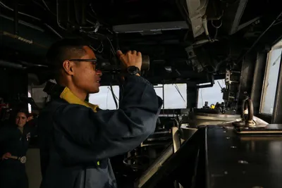 @U.S. Central Command: A U.S. sailor stands watch aboard USS Frank E. Petersen Jr. (DDG 121) as the ship patrols the Arabian Sea supporting the U.S. blockade against Iran. CENTCOM has redirected 17 commercial vessels, disab