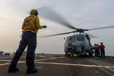 @U.S. Central Command: A U.S. Navy MH-60R Sea Hawk helicopter is prepared for flight aboard USS Michael Murphy (DDG 112) as the warship supports the U.S. blockade against Iran while sailing in regional waters. As of July 31
